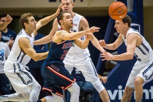 Chris Detrick  |  The Salt Lake Tribune
St. Mary's Gaels guard Aaron Bright (20) passes around Brigham Young Cougars guard Chase Fischer (1) and Brigham Young Cougars guard Skyler Halford (23) during the game at the Marriott Center Thursday February 12, 2015.