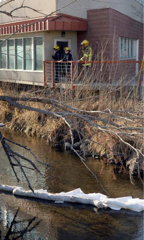 Al Hartmann  |  The Salt Lake Tribune
The Unified Fire Department investigates an oily sheen on Mill Creek at 700 East and 3300 South Friday, Feb. 13, 2015. They placed several booms along the creek to catch some of the oily substance. Unified Fire thought the substance was confined to the creek from 700 East to 200 East. The source was not immediately known.