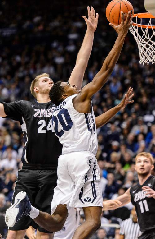 Trent Nelson  |  The Salt Lake Tribune
Brigham Young Cougars guard Anson Winder (20) puts up a shot ahead of Gonzaga Bulldogs center Przemek Karnowski (24) as BYU hosts Gonzaga, men's college basketball at the Marriott Center in Provo, Saturday December 27, 2014.