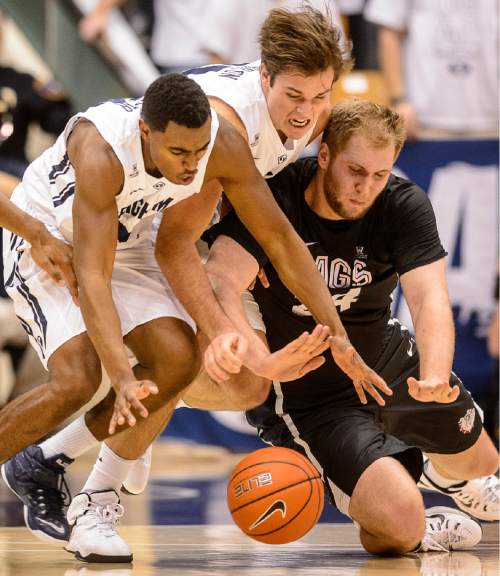 Trent Nelson  |  The Salt Lake Tribune
Brigham Young Cougars guard Anson Winder (20), Brigham Young Cougars forward Luke Worthington (41) and Gonzaga Bulldogs center Przemek Karnowski (24) scramble for a loose ball as BYU hosts Gonzaga, men's college basketball at the Marriott Center in Provo, Saturday December 27, 2014.