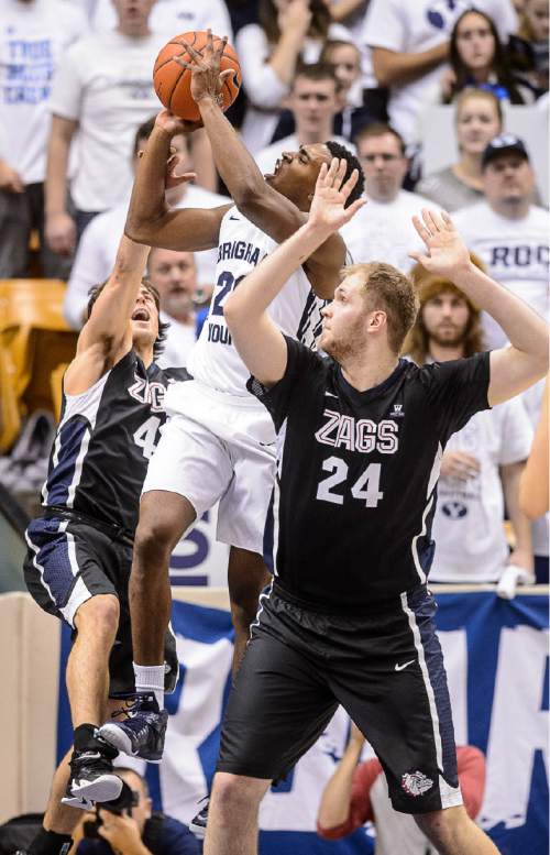 Trent Nelson  |  The Salt Lake Tribune
Brigham Young Cougars guard Anson Winder (20) puts up a shot, defended by Gonzaga Bulldogs guard Kevin Pangos (4) and center Przemek Karnowski (24) as BYU hosts Gonzaga, men's college basketball at the Marriott Center in Provo, Saturday December 27, 2014.