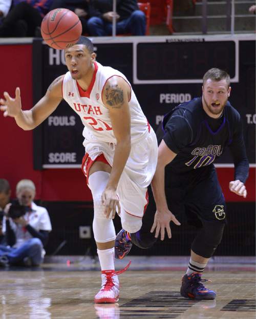 Utah forward Jordan Loveridge (21) steals the ball from Carroll's Jake Hollifield during an NCAA college basketball game Tuesday, Dec. 30, 2014, in Salt Lake City. (AP Photo/The Salt Lake Tribune, Leah Hogsten)