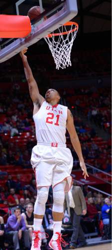 Leah Hogsten  |  The Salt Lake Tribune
Utah Utes forward Jordan Loveridge (21) hits the net. The University of Utah leads Carroll College 54-23 Tuesday, December 30, 2014 at the Jon M. Huntsman Center.