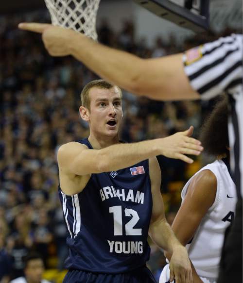 Steve Griffin  |  The Salt Lake Tribune

Brigham Young Cougars forward Josh Sharp (12) tells the ref that the ball went of a Utah State player during first half action in the BYU versus USU men's basketball game in Logan, Tuesday, December 2, 2014.