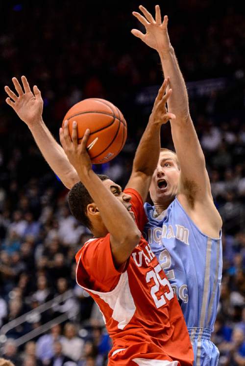 Trent Nelson  |  The Salt Lake Tribune
Utah Utes guard Kenneth Ogbe (25) puts up a shot, defended by Brigham Young Cougars forward Josh Sharp (12) as BYU hosts Utah, college basketball at the Marriott Center in Provo, Wednesday December 10, 2014.