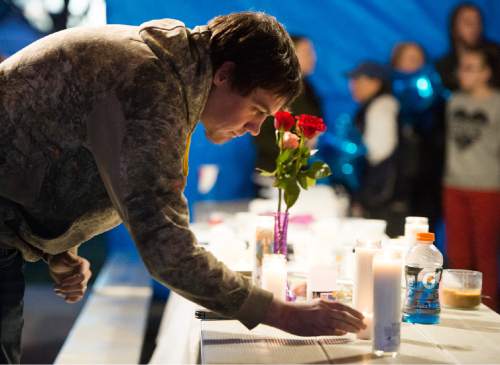 Rick Egan  |  The Salt Lake Tribune

Skyler Clements light a candle in memory of Cody Evans, 24, of Springville, who was fatally shot by police Sunday night, during a vigil, Monday, February 16, 2015
