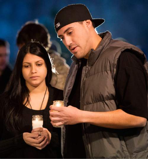 Rick Egan  |  The Salt Lake Tribune

Luciana Nadal, and Manny Armendariz light a candle, during a vigil for Cody Evans, 24, of Springville, who was fatally shot by police Sunday night.Monday, February 16, 2015