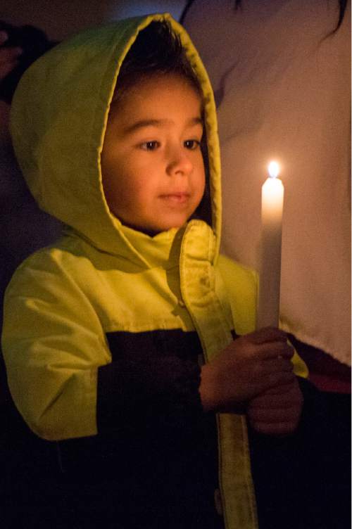 Rick Egan  |  The Salt Lake Tribune

Four-year-old Acetin Gonzalez lights candle for Cody Evans, during a candle-light vigil, at Pioneer Park in Provo, Monday, February 16, 2015. Evans, 24, was fatally shot by police Sunday night.