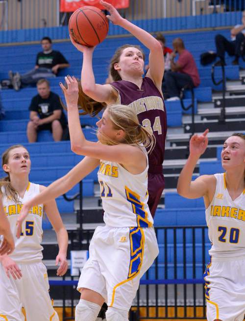 Leah Hogsten  |  The Salt Lake Tribune
Maple Mountain's MiKayla Hubbard shoots over the back of Bonneville's Mykel Davis. Maple Mountain High School girls basketball team defeated Bonneville High School 55-44 during the 4A State Championships first round game, Tuesday, February 17, 2015 at Salt Lake Community College's Lifetime Activities Center .