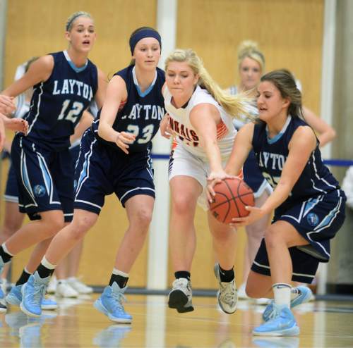 Steve Griffin  |  The Salt Lake Tribune

Brighton's McCall Christensen (22), center, tries to knock the ball away from Layton's Livia Borges (35) during second round game of the girl's 5A basketball state tournament at SLCC in Taylorsville, Wednesday, February 18, 2015.