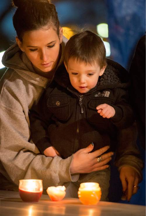 Rick Egan  |  The Salt Lake Tribune

Jackie Sauter lights a candle for Cody Evans with her 2-year-old son Beau Seamons during a candlelight vigil at Pioneeer Park in Provo, Monday, Feb. 16, 2015. Evans, 24, was fatally shot by police Sunday.
