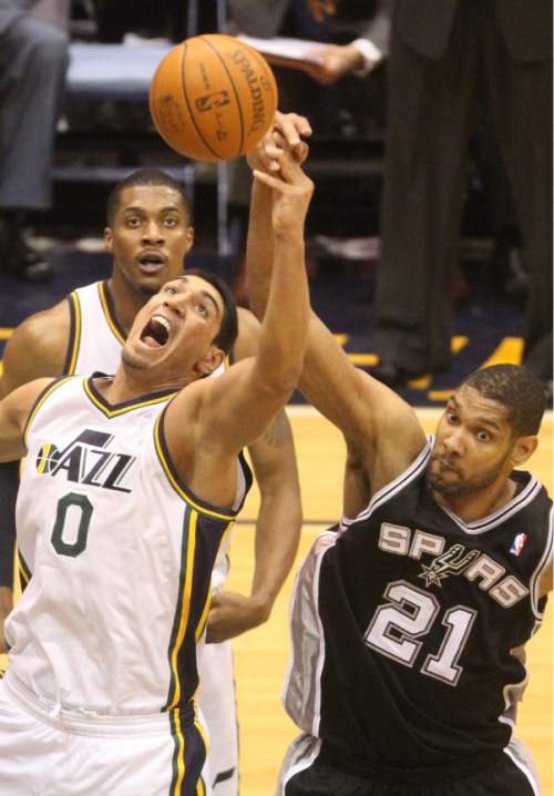 Rick Egan  | The Salt Lake Tribune 

Utah Jazz forward Enes Kanter (0) goes for the ball along with San Antonio Spurs center Tim Duncan (21), in NBA playoff action at the EnergySolutions Arena, Saturday, May 5, 2012.