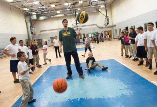 Steve Griffin  |  The Salt Lake Tribune


Utah Jazz player Enes Kanter plays basketball with children in the after school program at the Sorenson Multicultural Center in Salt Lake City, Tuesday, October 14, 2014. Kanter was at the center to play basketball and give the kids tickets, which he personally purchased, as part of his ongoing participation in the Jazz player ticket donation program.