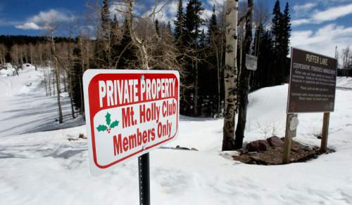 One of the questionable signs put up by the Mt. Holly Club at the access point to Puffer Lake, (behind).   About 20 feet to the right of this sign is a brown Division of Wildlife Rescources sign that states that Puffer Lake and lakes nearby are managed for recreational fishing by the Utah Division of Wildlife Rescources in cooperation with the private landowner.   This arrangement has existed for many years.  The new Mt. Holly sign discourages and confuses average folks into not walking down the access road to the lake.   Staff Photo/Salt Lake Tribune   3/15/07