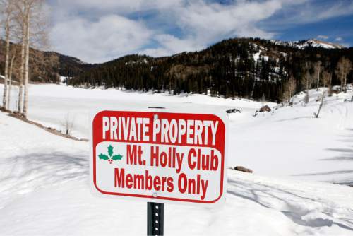 One of the questionable signs put up by the Mt. Holly Club at the access point to Puffer Lake, (behind).   About 20 feet to the right of this sign is a brown Division of Wildlife Rescources sign that states that Puffer Lake and lakes nearby are managed for recreational fishing by the Utah Division of Wildlife Rescources in cooperation with the private landowner.   This arrangement has existed for many years.  The new Mt. Holly sign discourages and confuses average folks into not walking down the access road to the lake.   Staff Photo/Salt Lake Tribune  3/15/07