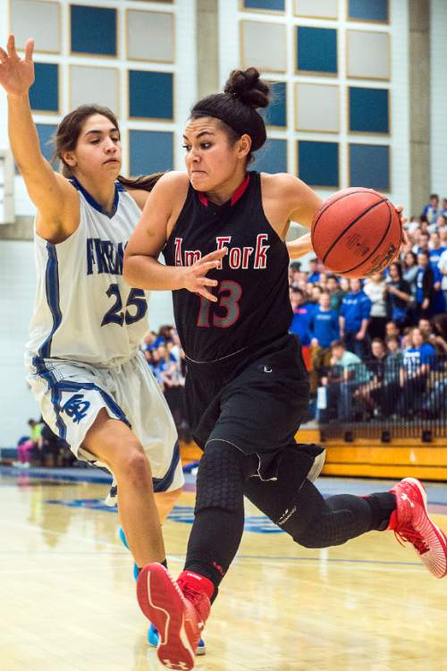 Chris Detrick  |  The Salt Lake Tribune
American Fork's Taylor Moeaki (13) runs past Fremont's Maryah Tipping (25) during the game at Salt Lake Community College Lifetime Activities Center  Friday February 20, 2015. Fremont defeated American Fork 38-37.
