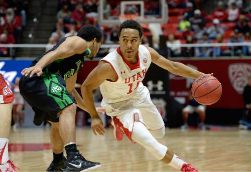Utah guard Brandon Taylor (11) drives against North Dakota guard Quinton Hooker (21) during the first half on an NCAA college basketball game, Friday, Nov. 28, 2014 in Salt Lake City. (AP Photo/The Salt Lake Tribune, Scott Sommerdorf)  DESERET NEWS OUT; LOCAL TELEVISION OUT; MAGS OUT