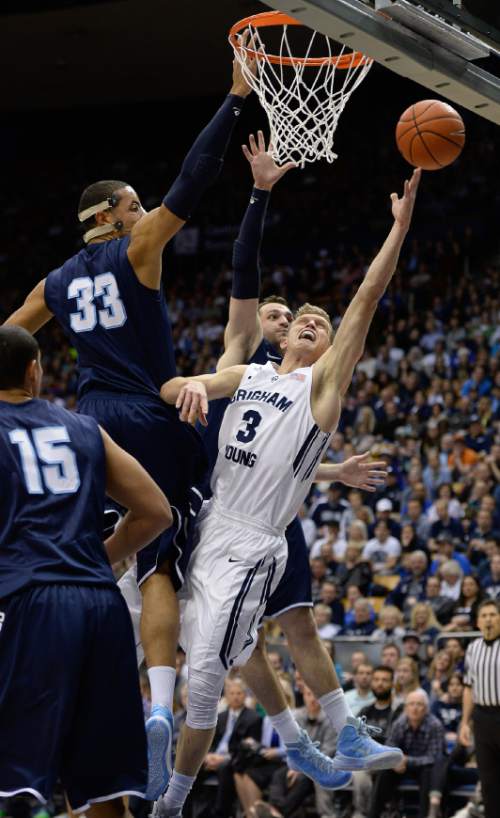 Francisco Kjolseth  |  The Salt Lake Tribune 
Tyler Haws of BYU finds a narrow opening to score a basket against San Diego in game action at the Marriott Center in Provo on Thursday, Feb. 19, 2015.