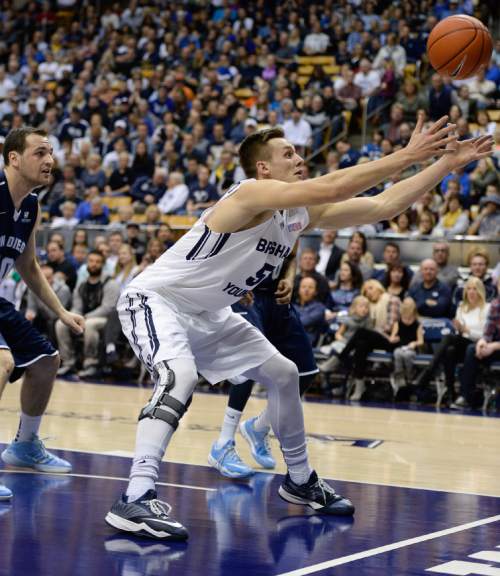 Francisco Kjolseth  |  The Salt Lake Tribune 
Kyle Collinsworth tries to keep an ball in play against San Diego in game action at the Marriott Center in Provo on Thursday, Feb. 19, 2015.