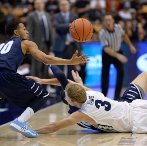 Francisco Kjolseth  |  The Salt Lake Tribune 
Tyler Haws of BYU goes to the floor as Chris Anderson of San Diego moves in for the ball in game action at the Marriott Center in Provo on Thursday, Feb. 19, 2015.
