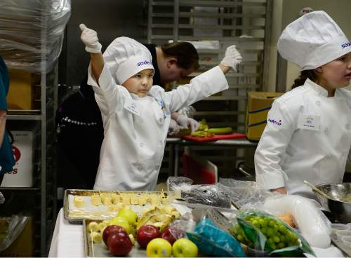 Scott Sommerdorf   |  The Salt Lake Tribune
Gabriel Zubiran Jr., a 4th grader at David Gourley Elementary loosens up his chef's coat as he is about to get into the construction of his dish "Banana Snowman" during the Granite School District 2015 Future Chefs competition, Friday, February 20, 2015.