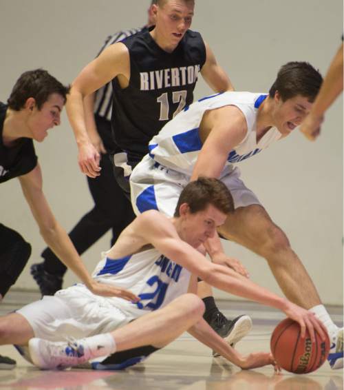 Rick Egan  |  The Salt Lake Tribune

Bingham forward Jared Holman (24) and Josh Newbold (32) go for a loose ball along with Riverton guard John Arens (30), in 5A Boys Basketball State Tournament action, Bingham vs Riverton, at the Dee Event Center, Monday, February 23, 2015