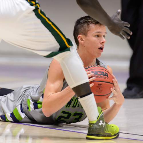 Trent Nelson  |  The Salt Lake Tribune
Timpanogos's Conner Halford (23) looks to pass, defended by Kearns's Bushmen Ebet (1), as Kearns faces Timpanogos High School in the state 4A boys basketball tournament at the Dee Events Center in Ogden, Tuesday February 24, 2015.