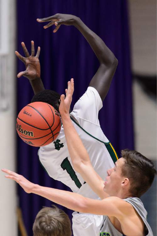Trent Nelson  |  The Salt Lake Tribune
Timpanogos's Conner Halford (23) reaches behind Kearns's Buay Kuajian (11) for the ball as Kearns faces Timpanogos High School in the state 4A boys basketball tournament at the Dee Events Center in Ogden, Tuesday February 24, 2015.