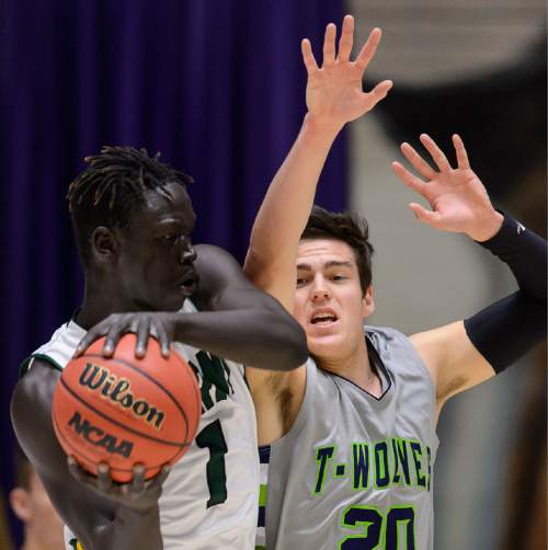 Trent Nelson  |  The Salt Lake Tribune
Kearns's Bushmen Ebet (1), defended by Timpanogos's Arthur Coombs IV as Kearns faces Timpanogos High School in the state 4A boys basketball tournament at the Dee Events Center in Ogden, Tuesday February 24, 2015.