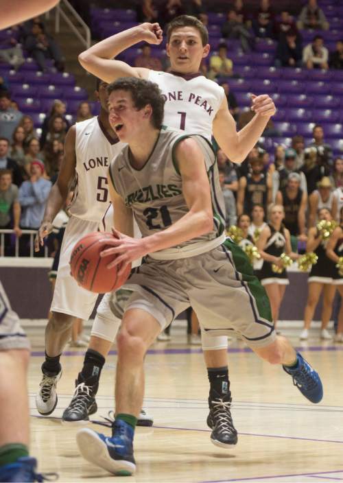 Rick Egan  |  The Salt Lake Tribune

Copper Hills guard Charlie Olsen (21) gets past Lone Peak guard Tyson Doman (1), in 5A Boys Basketball StateTournament action, Lone Peak vs Copper Hills, at the Dee Event Center, Monday, February 23, 2015