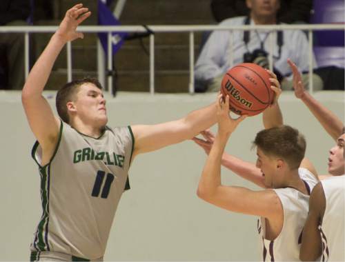 Rick Egan  |  The Salt Lake Tribune

Nick Curtis, Lone Peak, is guarded by Copper Hills center Porter Hawkins (11) in 5A Boys Basketball StateTournament action, Lone Peak vs Copper Hills, at the Dee Event Center, Monday, February 23, 2015