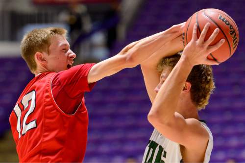 Trent Nelson  |  The Salt Lake Tribune
East's Hayden Banz (12) defending Olympus' Miles Keller (23) as East faces Olympus High School in the state 4A boys basketball tournament at the Dee Events Center in Ogden, Tuesday February 24, 2015.