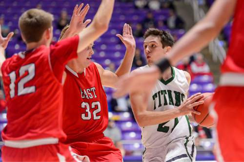 Trent Nelson  |  The Salt Lake Tribune
Olympus' Jake Lindsey (21) drives to the basket, with East's Hayden Banz (12) and East's Blake Hansen (32) defending, as East faces Olympus High School in the state 4A boys basketball tournament at the Dee Events Center in Ogden, Tuesday February 24, 2015.