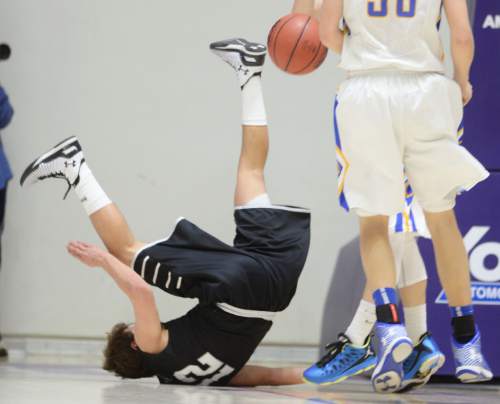 Steve Griffin  |  The Salt Lake Tribune

Highland's Spencer Divver (12) crashes to the floor after fliping over Orem's Hayden Young (3) after falling for a pump fake during opening round of the boy's 4A basketball state tournament game at the Dee Event Center in Ogden, Tuesday, February 24, 2015.
