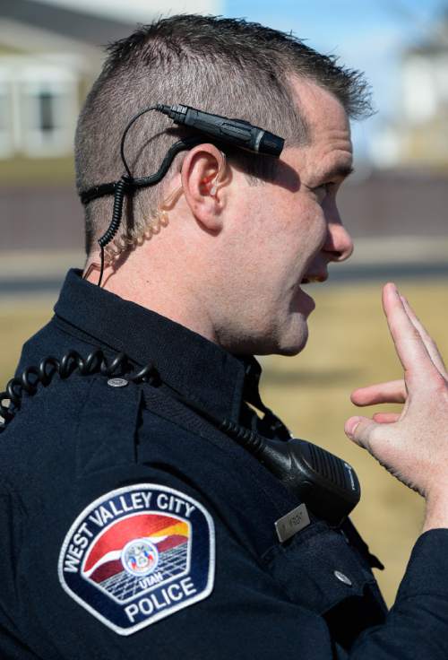 Francisco Kjolseth  |  The Salt Lake Tribune 
West Valley City patrol officer Wade Wright, discusses the workings of the department's newly issued body cameras they are using. The department, which opted for the over the ear option, should have all their officers equipped with one by Monday.