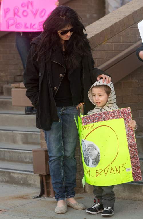 Rick Egan  |  The Salt Lake Tribune

Cody Evans' wive Joana Evans stands with their 3-year-old son, Dylan, on the steps of the Provo Police Station during a rally in Provo, Wednesday, February 25, 2015