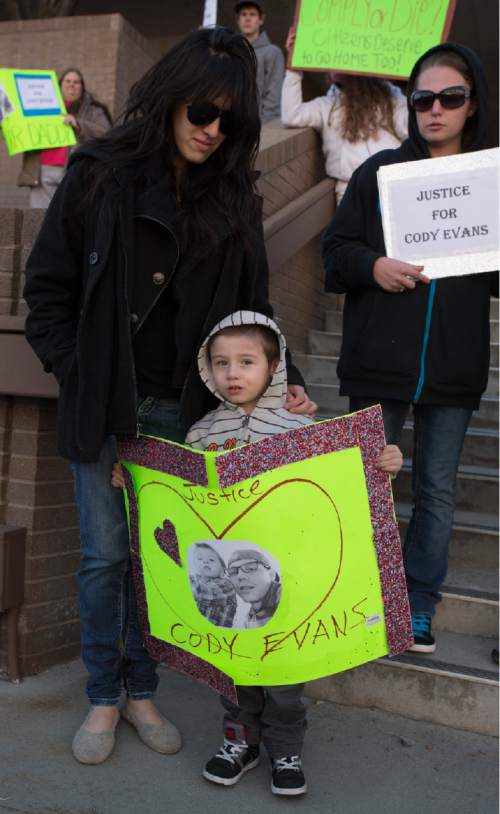 Rick Egan  |  The Salt Lake Tribune

Cody Evans' wive Joana Evans stands with their 3-year-old son, Dylan, on the steps of the Provo Police Station during a rally in Provo, Wednesday, February 25, 2015