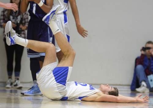Steve Griffin  |  The Salt Lake Tribune

Bingham's Josh Newbold (32) falls to the floor after picking up a charging foul during quarterfinals of the boy's 5A basketball state tournament game against Layton at the Dee Event Center in Ogden, Wednesday, February 25, 2015.