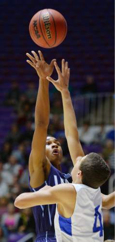 Steve Griffin  |  The Salt Lake Tribune

Layton's Julian Blackmon flips a shot over Bingham's Dason Youngblood (4)  during quarterfinals of the boy's 5A basketball state tournament game against Bingham at the Dee Event Center in Ogden, Wednesday, February 25, 2015.