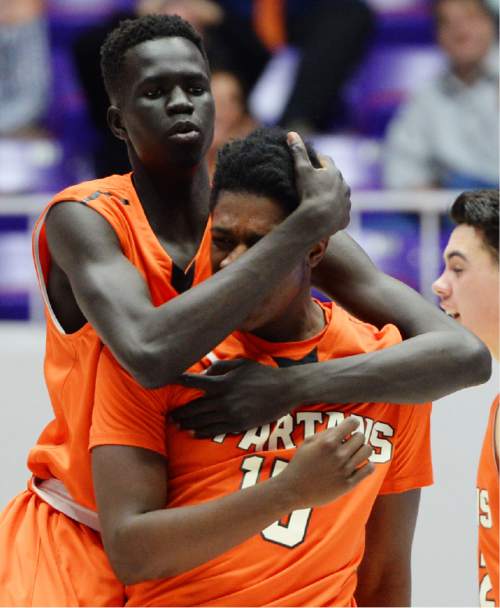 Steve Griffin  |  The Salt Lake Tribune

Murray's Lual Arok (20) hugs Aubrey Hodges (15) after Hodges nailed a jumper with three seconds left in the game giving Murray the lead over Bountiful during boy's 4A basketball state tournament game against Bountiful at the Dee Event Center in Ogden, Tuesday, February 24, 2015.