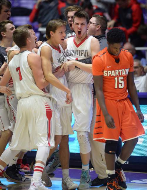 Steve Griffin  |  The Salt Lake Tribune

Teammates mob Bountiful's Zachary Seljaas (1) after he nailed a jumper with no time left on the clock giving the Braves a last second victory over Murray during opening round of the boy's 4A basketball state tournament at the Dee Event Center in Ogden, Tuesday, February 24, 2015. A dejected Aubrey Hodges (15), of Murray, walks off the court, right, following the game. Hodges connected on a jumper with three seconds left in the game giving Murray the lead.