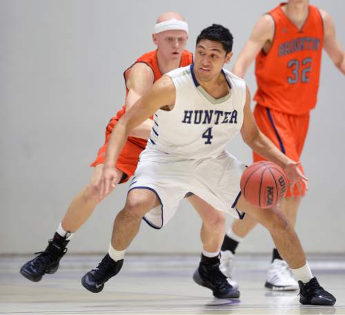 Steve Griffin  |  The Salt Lake Tribune

Hunter's Noah Togiai (4) tries to spin past Brighton's Brock Miller (3) during quarterfinals of the boy's 5A basketball state tournament game at the Dee Event Center in Ogden, Wednesday, February 25, 2015.
