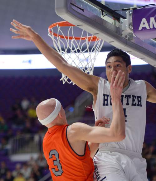Steve Griffin  |  The Salt Lake Tribune

Hunter's Noah Togiai (4) soars above Brighton's Brock Miller (3) blocking his shot during quarterfinals of the boy's 5A basketball state tournament game at the Dee Event Center in Ogden, Wednesday, February 25, 2015.