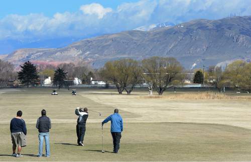 Scott Sommerdorf   |  The Salt Lake Tribune
Golfers tee off at Glendale Golf Course, Sunday, February 15, 2015.