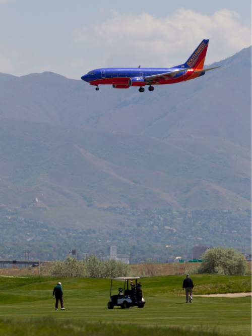 Trent Nelson  |  The Salt Lake Tribune
A Southwest Airlines jet passes over golfers on the 9th hole at Salt Lake City's Wingpointe golf course Wednesday, May 2, 2012.  A demand from the FAA could cause a dramatic increase in Wingpointe's lease.