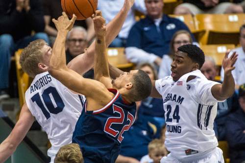 Chris Detrick  |  The Salt Lake Tribune
St. Mary's Gaels forward Garrett Jackson (22) shoots past Brigham Young Cougars forward Ryan Andrus (10) and Brigham Young Cougars guard Frank Bartley IV (24) during the game at the Marriott Center Thursday February 12, 2015.
