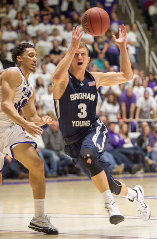 Rick Egan  |  The Salt Lake Tribune

Weber State Wildcats guard Jeremy Senglin (30) defends as Brigham Young Cougars guard Tyler Haws (3) loses control of the ball, as he goes in for a lay-up, in basketball action BYU vs Weber State, at the Dee Events Center in Ogden, Saturday, December 13, 2014