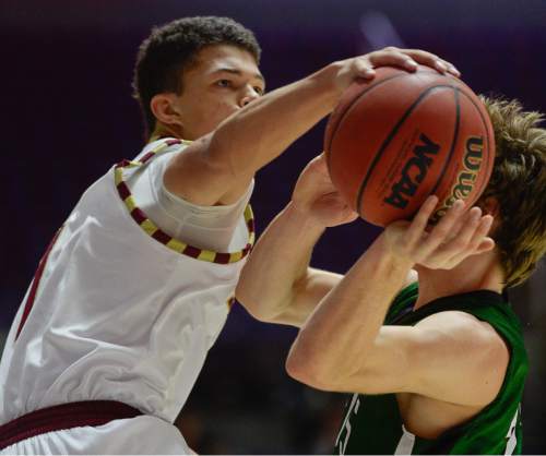 Francisco Kjolseth  |  The Salt Lake Tribune 
Olympus's Elias Falk (22) is swatted by Maple Mountain's Jaren Hall (1) on his drive attempt to the basket in 4A boys' hoops quarterfinal at the Dee Events Center in Ogden on Thursday, Feb. 26, 2015.