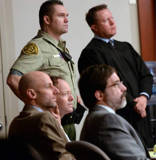Al Hartmann  |  The Salt Lake Tribune
Johnny Brickman Wall, center bottom, with his defense lawyers Jeremy Delicino and Fred Metos, listens to blood pattern expert Rod Englert give a crash course on blood smears to the jury in 3rd District Court Thursday Feb. 19, 2015, in Salt Lake City. The court bailiff and Judge James Blanch at top watch the demonstration. Wall is accused of killing his former wife and researcher Uta von Schwedler in her Sugar House home in September 2011.