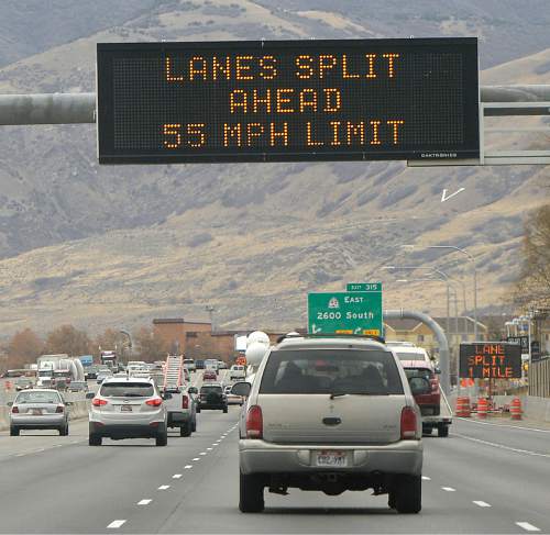 Al Hartmann  |   Tribune file photo
Four lanes of traffic along I-15 northbound near Woods Cross are warned of the upcoming traffic split ahead for a freeway construction project.